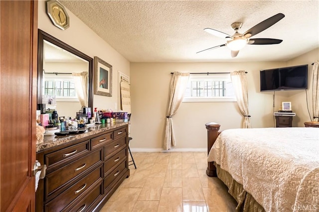 727 W Hill St, Long Beach, CA 90806 - bedroom with a textured ceiling, baseboards, and ceiling fan