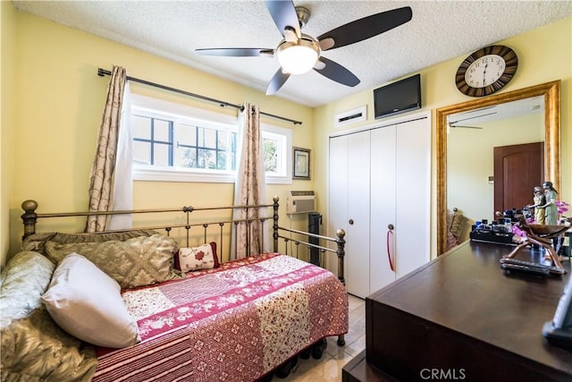 727 W Hill St, Long Beach, CA 90806 - tiled bedroom with a closet, a textured ceiling, and a ceiling fan