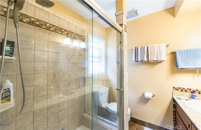 727 W Hill St, Long Beach, CA 90806 - bathroom featuring toilet, vanity, a shower stall, and tile patterned flooring