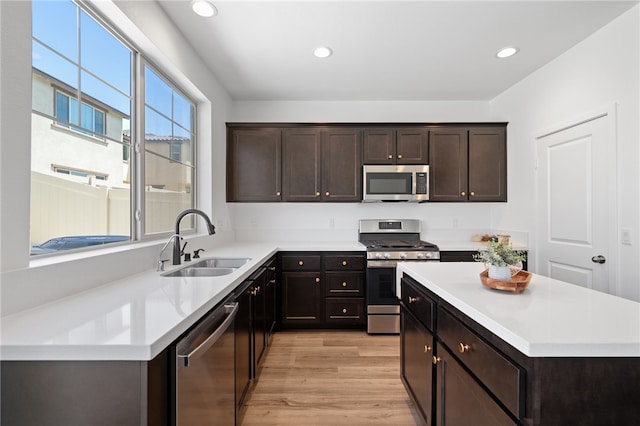29562 Winterstorm Ct, Winchester, CA 92596 - kitchen with stainless steel appliances, a sink, light wood-style floors, light countertops, and recessed lighting