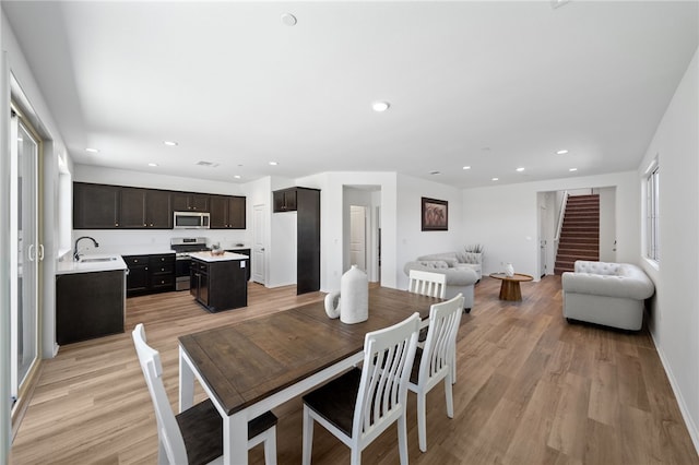 29562 Winterstorm Ct, Winchester, CA 92596 - dining area featuring stairs, light wood-type flooring, recessed lighting, and baseboards