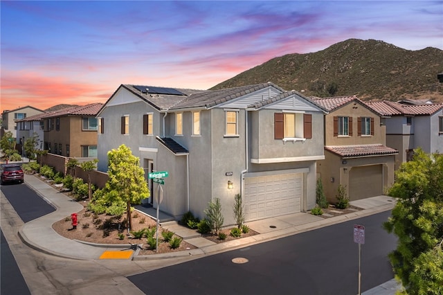 29562 Winterstorm Ct, Winchester, CA 92596 - view of property with a tile roof, an attached garage, stucco siding, a mountain view, and driveway
