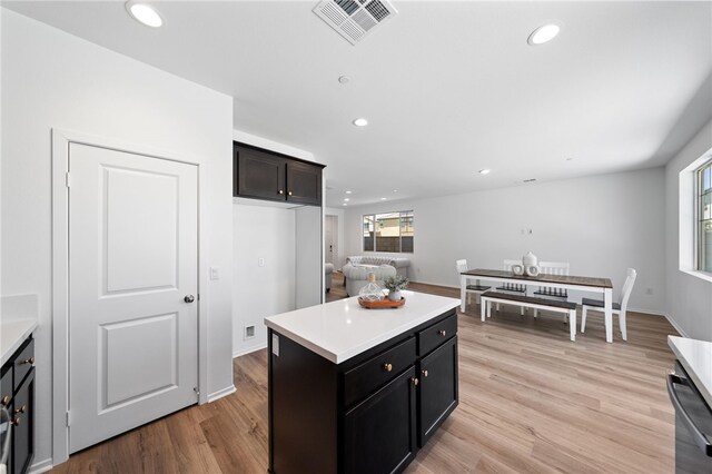 29562 Winterstorm Ct, Winchester, CA 92596 - kitchen with recessed lighting, light countertops, light wood-type flooring, stainless steel dishwasher, and a kitchen island