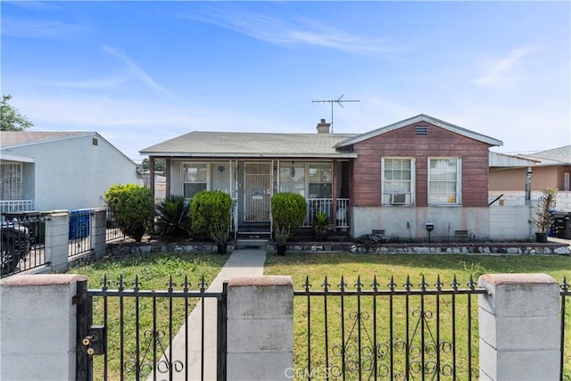 10443 E Zamora Ave, Los Angeles, CA 90002 - view of front facade featuring a porch, a fenced front yard, cooling unit, and a gate