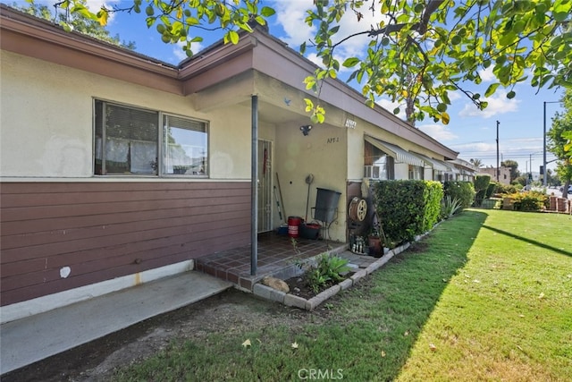 7614 Mason Ave, Winnetka, CA 91306 - view of side of home featuring a lawn and stucco siding