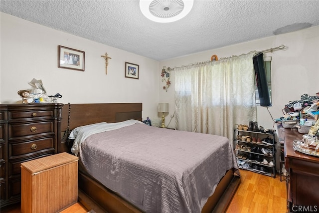 7614 Mason Ave, Winnetka, CA 91306 - bedroom with a textured ceiling and light wood-style floors
