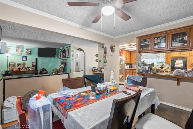 7614 Mason Ave, Winnetka, CA 91306 - dining room with a textured ceiling, wood finished floors, ceiling fan, crown molding, and baseboards