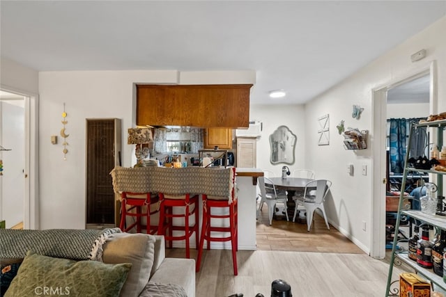 7614 Mason Ave, Winnetka, CA 91306 - living area with a heating unit and light wood-type flooring