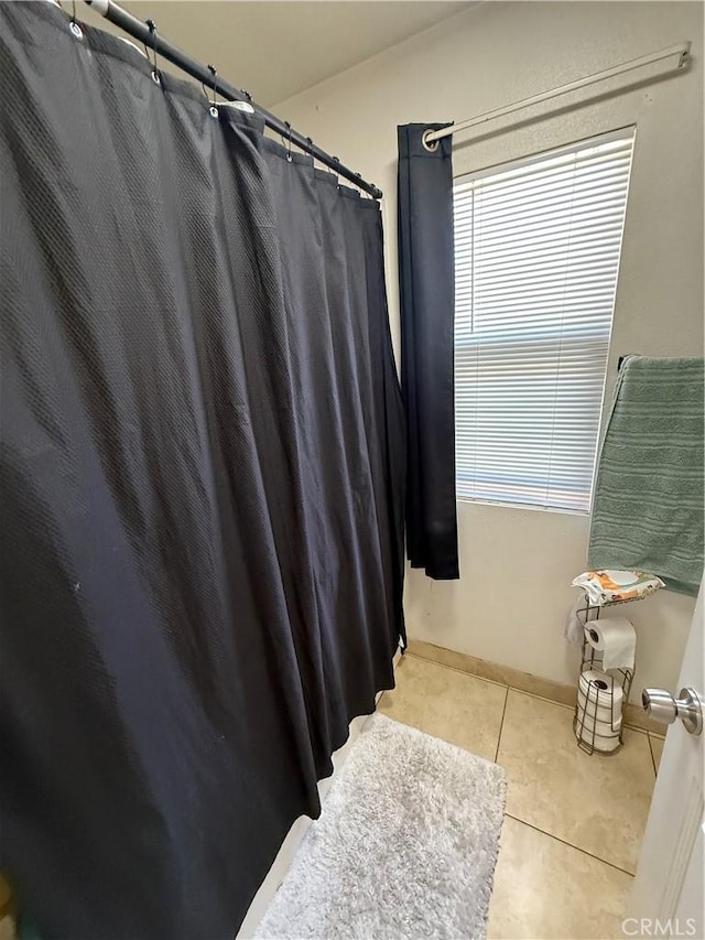 10333 Mendicino, Victorville, CA 92301 - bathroom featuring tile patterned floors, healthy amount of natural light, a shower with curtain, and baseboards