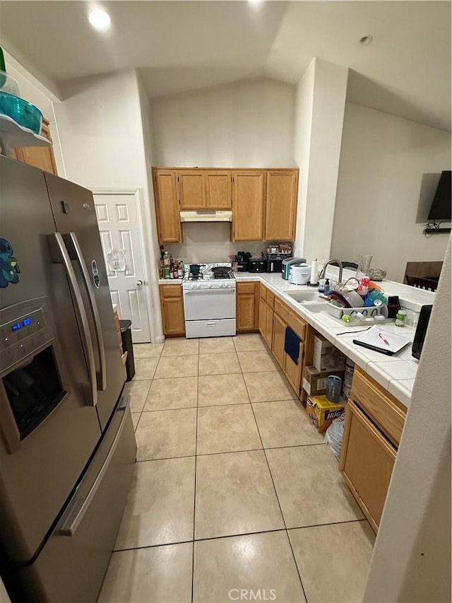 10333 Mendicino, Victorville, CA 92301 - kitchen featuring gas range gas stove, stainless steel fridge, under cabinet range hood, tile counters, and light tile patterned flooring