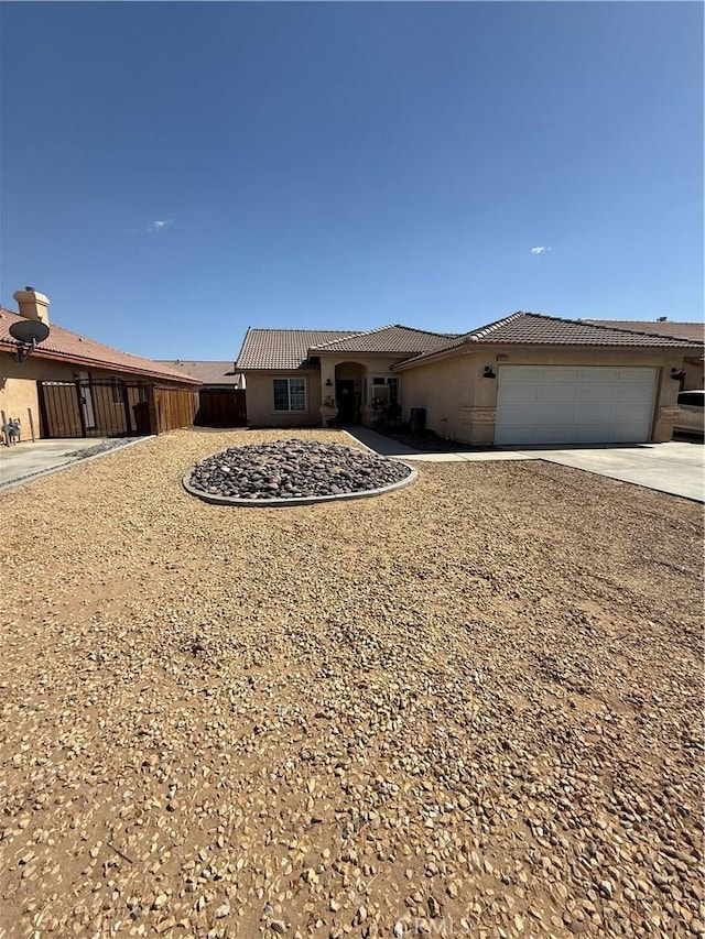 10333 Mendicino, Victorville, CA 92301 - view of front of home with a tiled roof, stucco siding, an attached garage, and concrete driveway