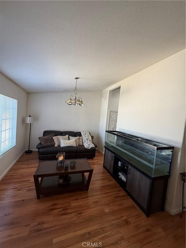10333 Mendicino, Victorville, CA 92301 - living area with a chandelier, wood finished floors, a textured ceiling, and baseboards