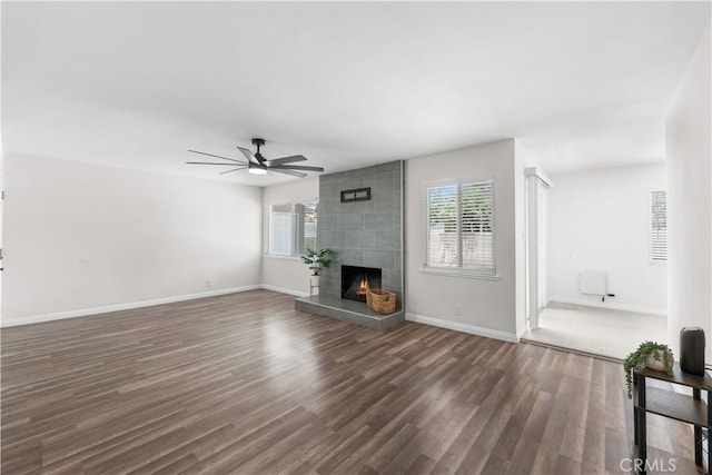 2398 Victoria St, San Bernardino, CA 92410 - unfurnished living room with healthy amount of natural light, a ceiling fan, a large fireplace, and wood finished floors