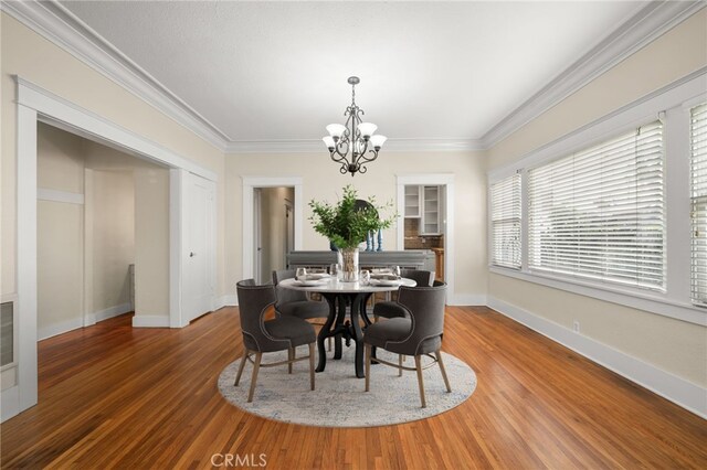 219 Redondo Ave, Long Beach, CA 90803 - dining room with a chandelier, wood finished floors, crown molding, and baseboards