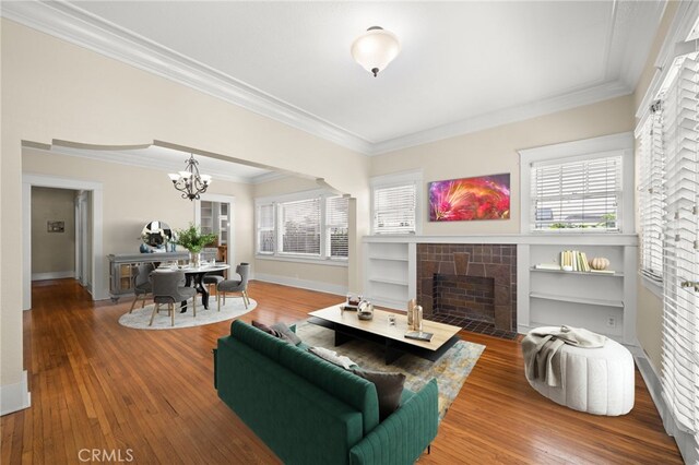 219 Redondo Ave, Long Beach, CA 90803 - living room with a chandelier, a fireplace, crown molding, hardwood / wood-style floors, and baseboards
