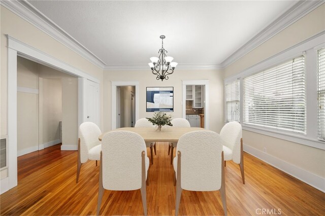 219 Redondo Ave, Long Beach, CA 90803 - dining space with a chandelier, light wood finished floors, crown molding, and baseboards