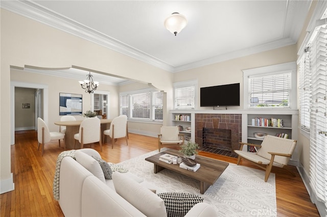 219 Redondo Ave, Long Beach, CA 90803 - living room with wood finished floors, ornamental molding, a chandelier, and a fireplace