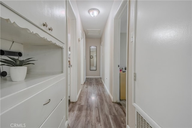1016 N Marcella Ave, Rialto, CA 92376 - hall with light wood-style floors, attic access, and baseboards