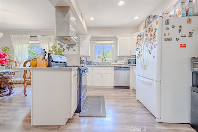 1016 N Marcella Ave, Rialto, CA 92376 - kitchen with appliances with stainless steel finishes, plenty of natural light, white cabinetry, light wood finished floors, and recessed lighting