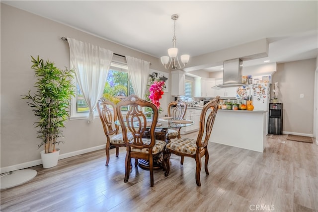 1016 N Marcella Ave, Rialto, CA 92376 - dining room featuring a chandelier, light wood-type flooring, and baseboards