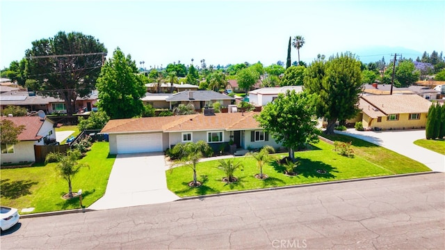 1016 N Marcella Ave, Rialto, CA 92376 - ranch-style house with a residential view, concrete driveway, a front yard, and an attached garage