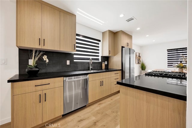 505 N Avon St, Burbank, CA 91505 - kitchen featuring stainless steel appliances, light brown cabinetry, a sink, tasteful backsplash, and light wood-type flooring