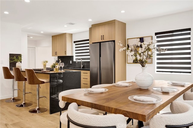 505 N Avon St, Burbank, CA 91505 - kitchen with freestanding refrigerator, light wood finished floors, a sink, dark countertops, and tasteful backsplash