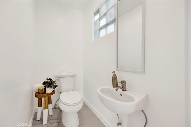 505 N Avon St, Burbank, CA 91505 - bathroom with baseboards, toilet, marble look tile flooring, and a sink
