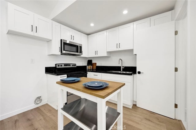 505 N Avon St, Burbank, CA 91505 - kitchen with stainless steel microwave, a sink, range with electric stovetop, light wood-style flooring, and recessed lighting