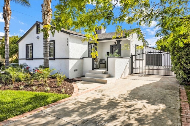 505 N Avon St, Burbank, CA 91505 - view of front of home featuring stucco siding, a gate, and driveway