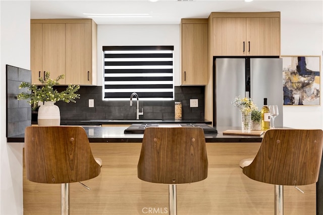 505 N Avon St, Burbank, CA 91505 - kitchen with freestanding refrigerator, decorative backsplash, a sink, and dark countertops
