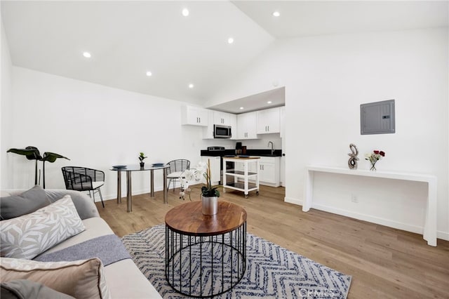 505 N Avon St, Burbank, CA 91505 - living area with electric panel, light wood-style flooring, recessed lighting, baseboards, and high vaulted ceiling