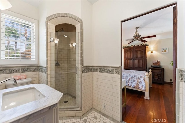 1422 Recado Rd, La Habra Heights, CA 90631 - full bathroom featuring tile walls, ceiling fan, a shower stall, vanity, and wainscoting