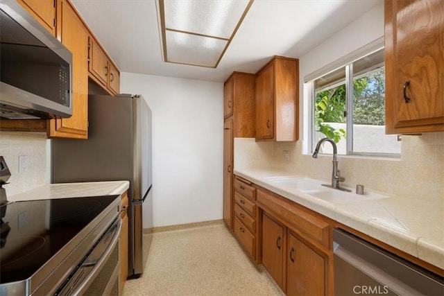 1750 Prefumo Canyon Rd Unit 17, San Luis Obispo, CA 93405 - kitchen with stainless steel appliances, tasteful backsplash, and brown cabinets