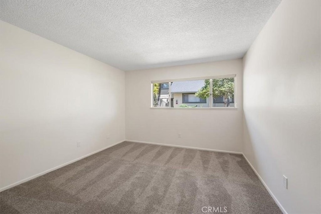 1750 Prefumo Canyon Rd Unit 17, San Luis Obispo, CA 93405 - spare room featuring carpet and a textured ceiling