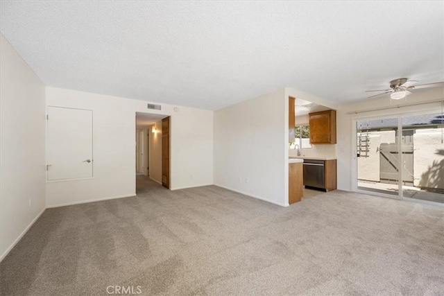 1750 Prefumo Canyon Rd Unit 17, San Luis Obispo, CA 93405 - unfurnished living room with a ceiling fan, light carpet, and a textured ceiling