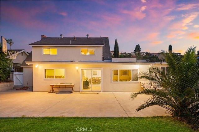 23929 Sunset Crossing Rd, Diamond Bar, CA 91765 - back of house at dusk featuring stucco siding, a gate, a patio, and a shingled roof