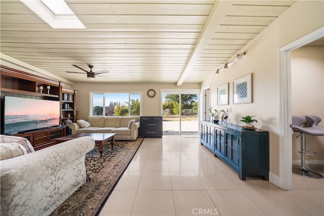 23929 Sunset Crossing Rd, Diamond Bar, CA 91765 - living area with wood ceiling, light tile patterned flooring, a skylight, ceiling fan, and baseboards