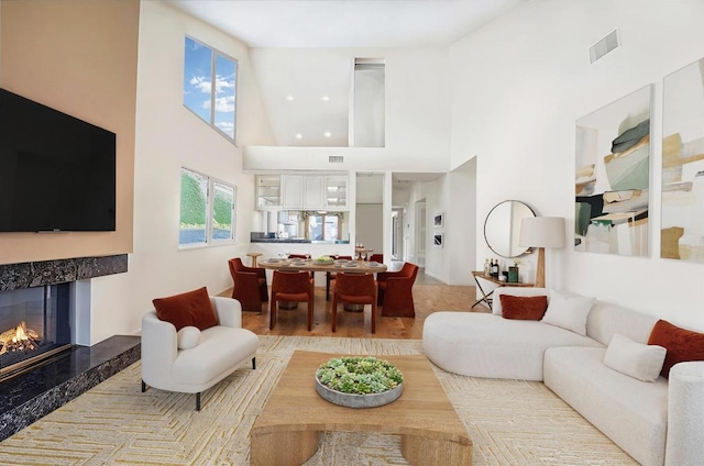 4074 Avenida Brisa, Rancho Santa Fe, CA 92091 - living room with a high ceiling, a tile fireplace, and wood finished floors