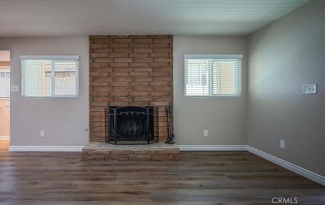 6391 Stearns St, Riverside, CA 92504 - unfurnished living room featuring healthy amount of natural light, a fireplace, wood finished floors, and baseboards