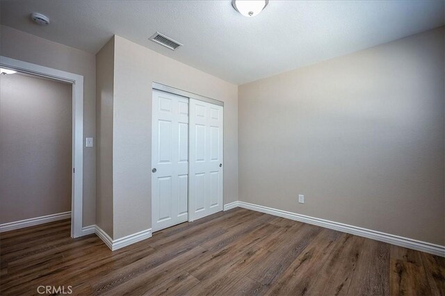 6391 Stearns St, Riverside, CA 92504 - unfurnished bedroom featuring wood finished floors, a closet, and baseboards