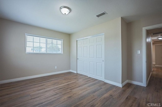 6391 Stearns St, Riverside, CA 92504 - unfurnished bedroom with a closet, wood finished floors, and baseboards