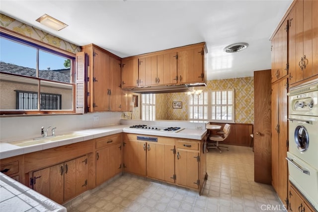 6130 Longridge Ave, Valley Glen, CA 91401 - kitchen featuring white stovetop, light floors, a warming drawer, and healthy amount of natural light