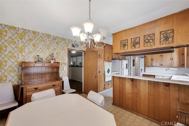 6130 Longridge Ave, Valley Glen, CA 91401 - dining space featuring wallpapered walls, a chandelier, and light flooring