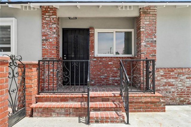 1304 N Devonshire Rd, Anaheim, CA 92801 - property entrance with brick siding, stucco siding, and a gate