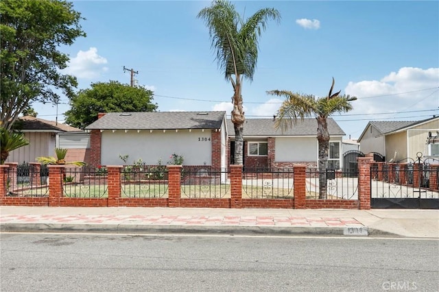 1304 N Devonshire Rd, Anaheim, CA 92801 - view of front of home with a fenced front yard and brick siding