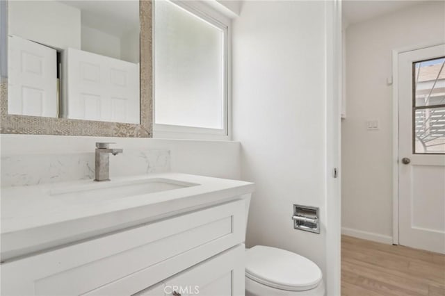 1304 N Devonshire Rd, Anaheim, CA 92801 - half bath with vanity, toilet, wood finished floors, and baseboards