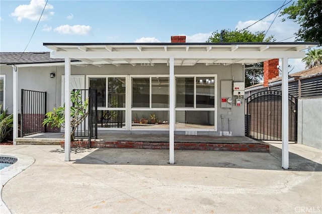1304 N Devonshire Rd, Anaheim, CA 92801 - rear view of property with stucco siding and a gate