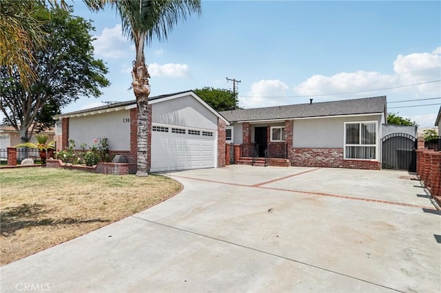 1304 N Devonshire Rd, Anaheim, CA 92801 - ranch-style home featuring concrete driveway, stucco siding, brick siding, an attached garage, and a gate