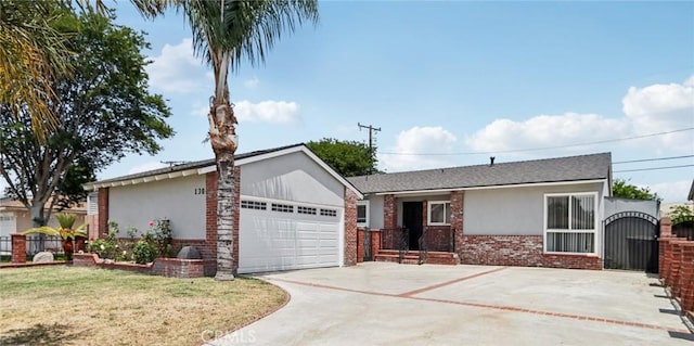 1304 N Devonshire Rd, Anaheim, CA 92801 - ranch-style home with stucco siding, brick siding, driveway, a garage, and a gate